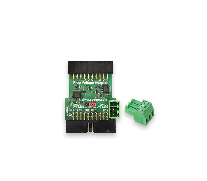 Programming Voltage Adapter This image shows a Prog Voltage Adapter circuit board with labeled connectors. It features a green PCB with various pins and connections for programming, including inputs for voltage and ground. A small, detachable green connector is also visible next to the adapter.